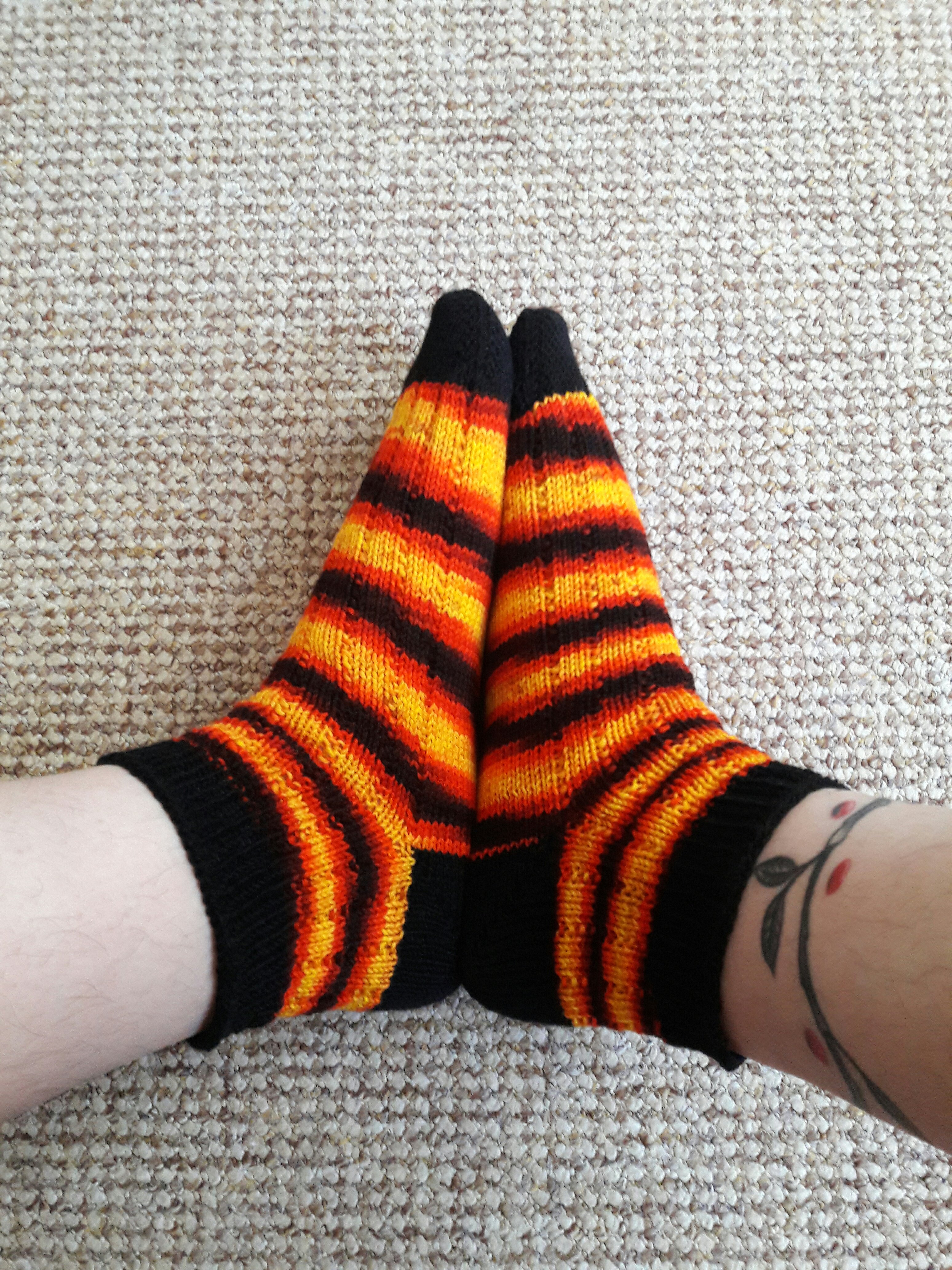 Photo of a pair of orange and black socks