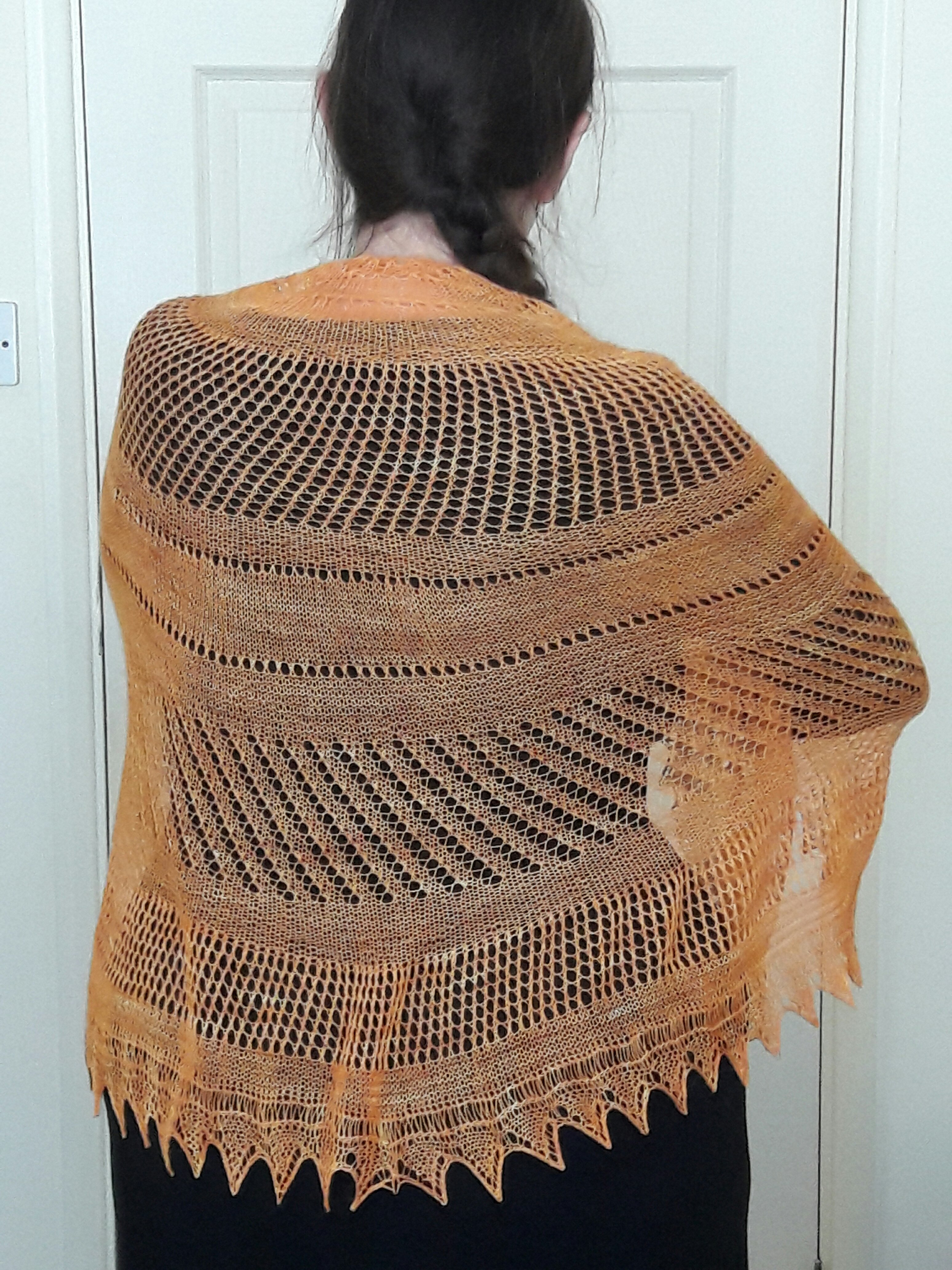 photo of completed shawl wrapped around the blogger