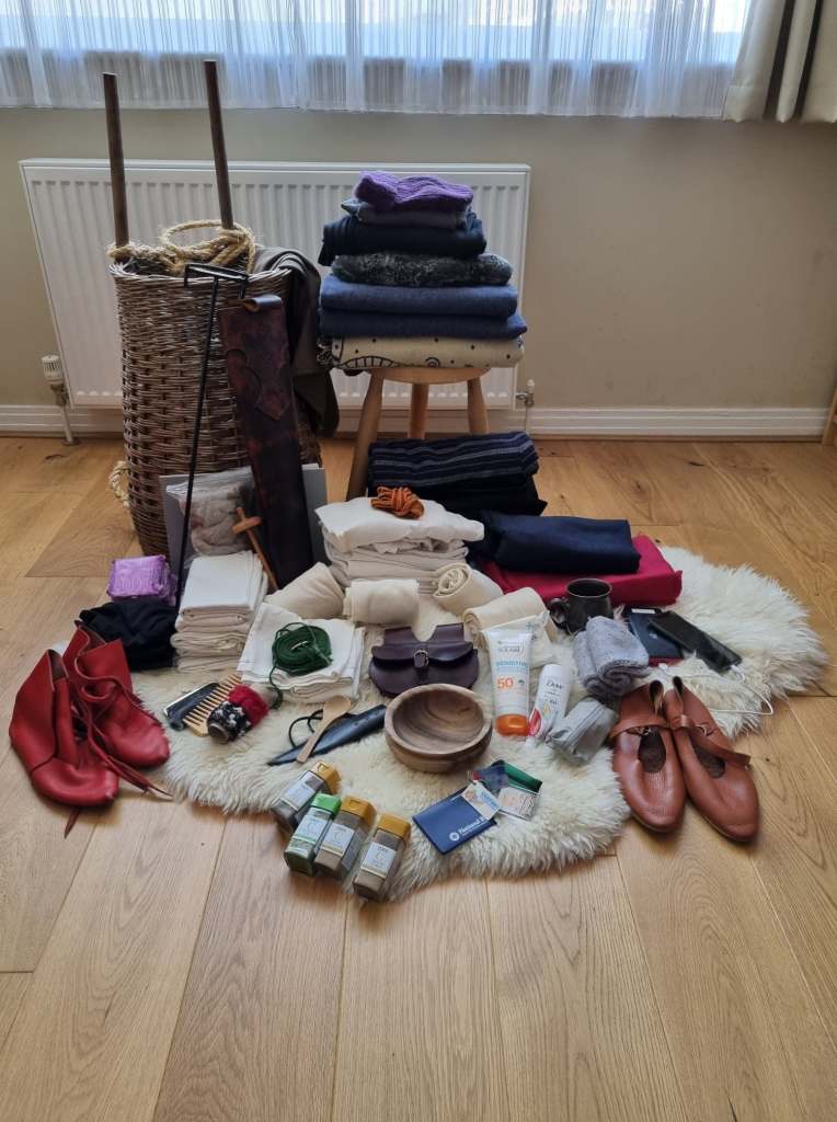 Photo of all the items from the earlier lists spread out on a wooden floor in front of a tall wicker basket.